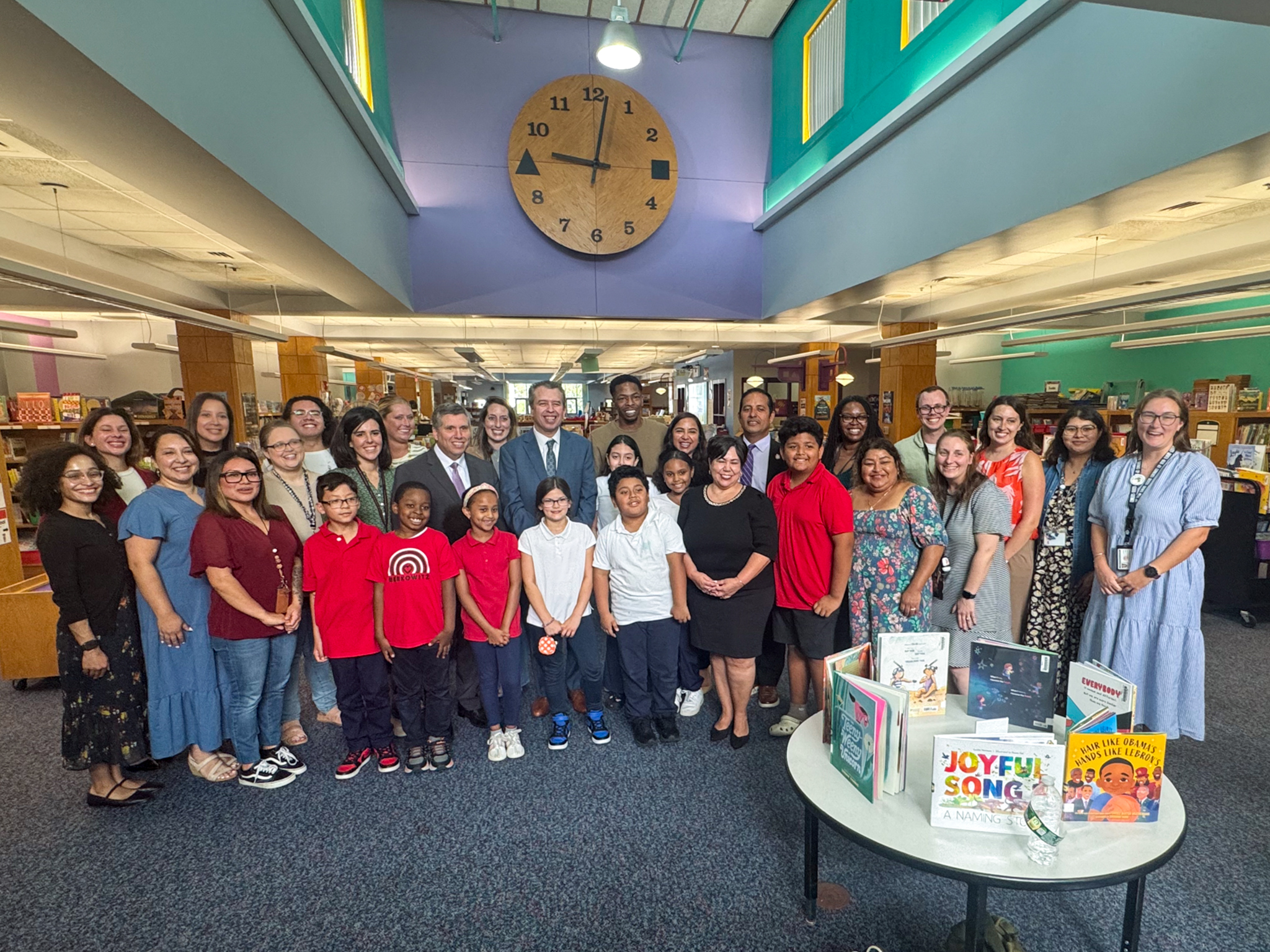 Group photo of Chelsea Public Schools staff and students joined by DESE Commissioner Pedro Martinez in the CPS Library
